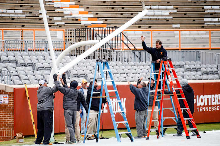 Workers reinstall the goalposts at Neyland Stadium.